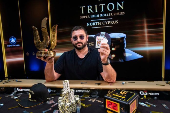 Ramin Hajiyev zwycięzca Luxon Invitational pozuje ze zwycięską ręką i pucharem.